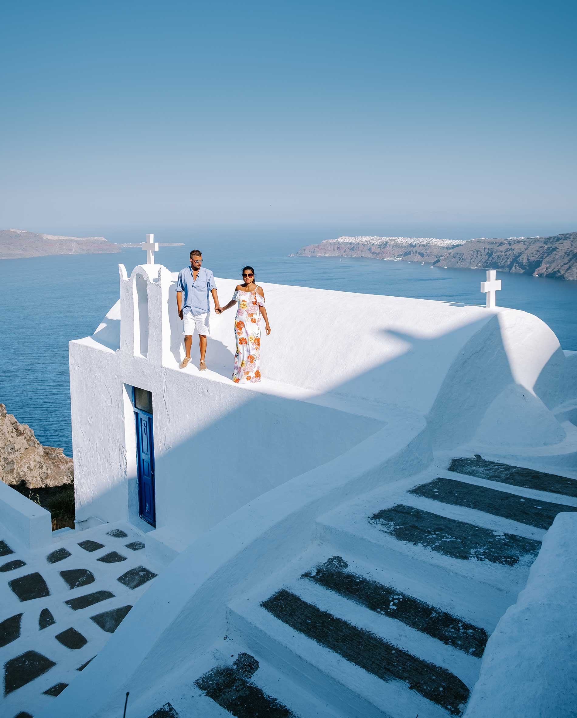 Santorini, Greece — couple enjoying the iconic blue domes