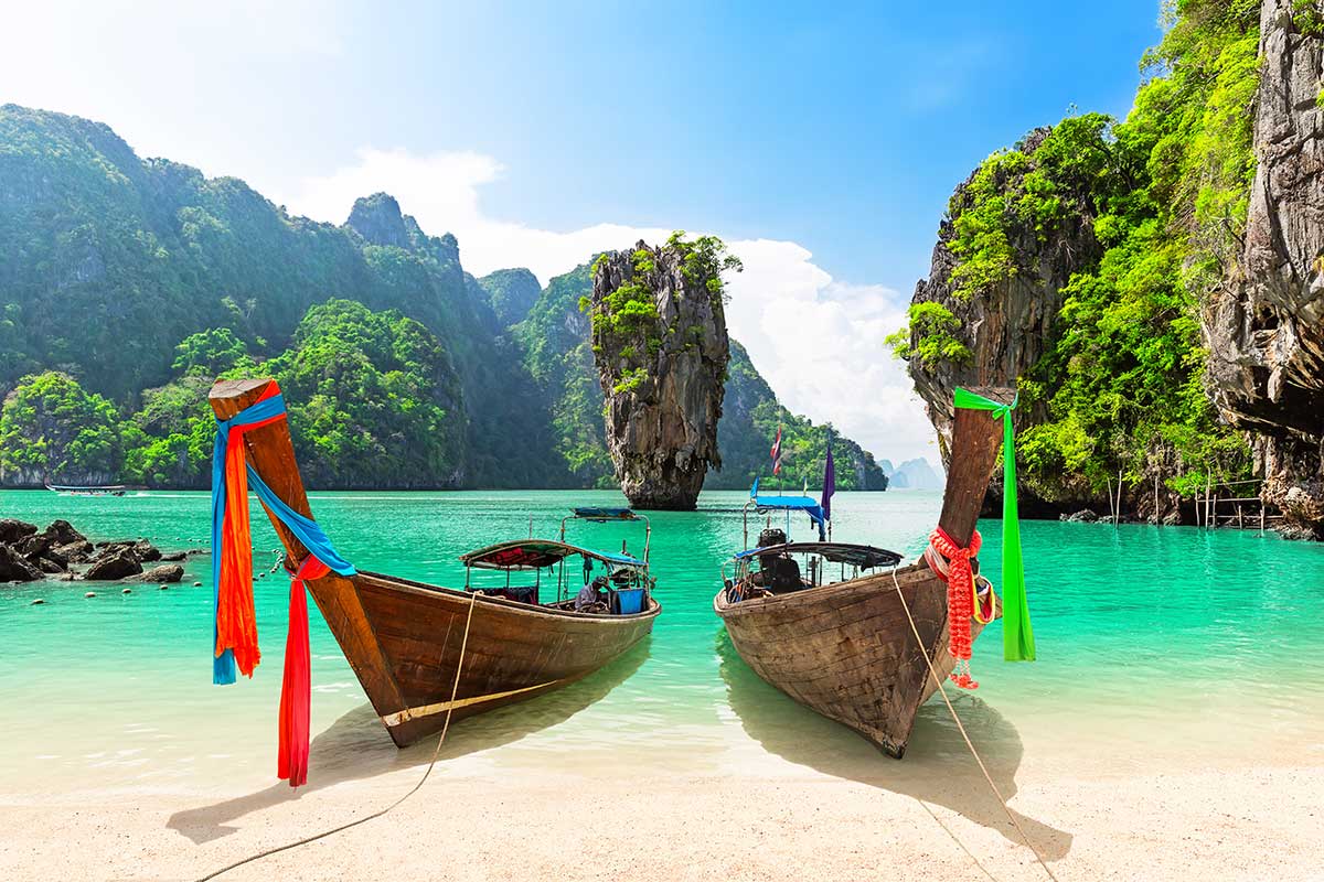 Thailand holidays from Australia — longtail boats among Krabi's limestone cliffs