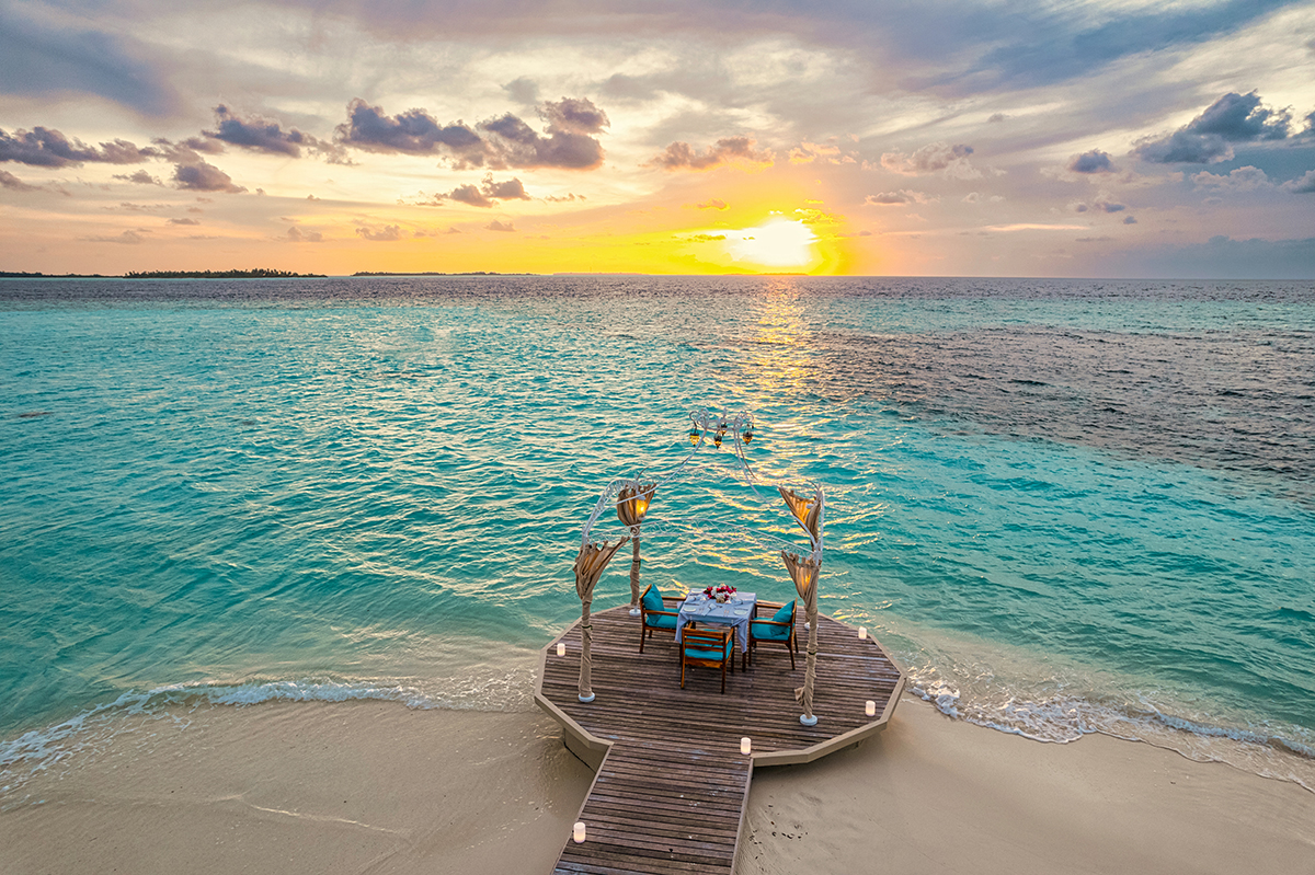 Honeymoon couple at an overwater villa in the Maldives